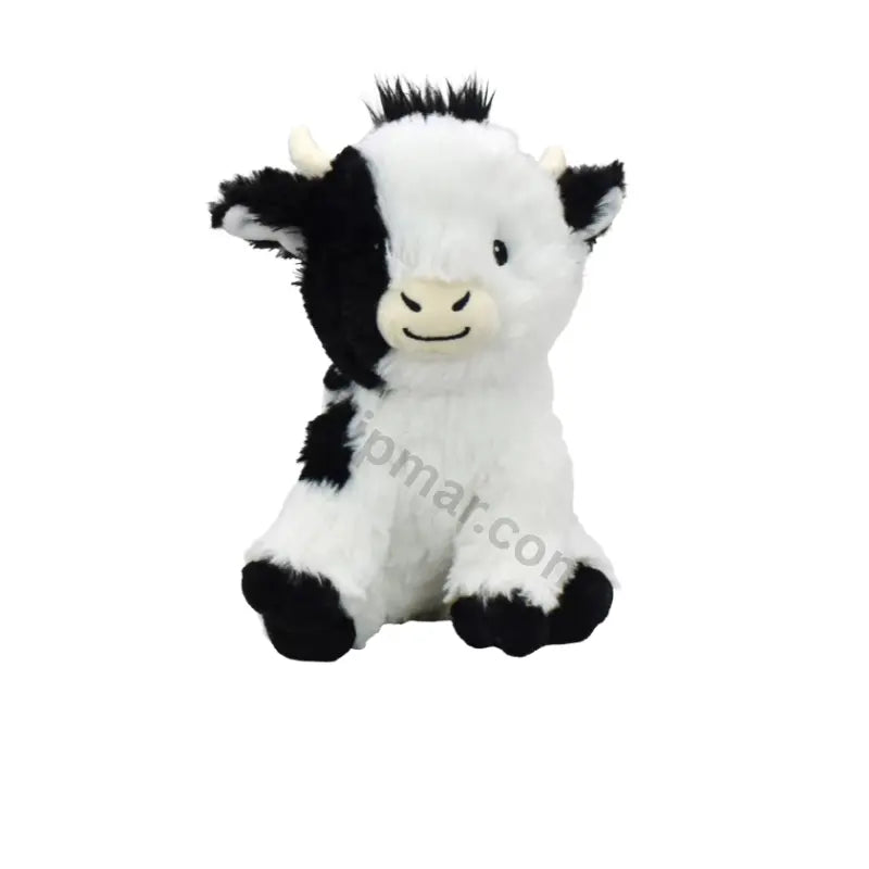 Multipet black and white cow plush dog toy front view with smiling face, cream snout and cream horns