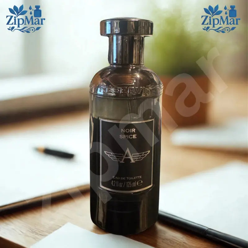 Noir Spice Eau de Toilette 4.2 fl oz 125 mL black glass bottle with silver winged A logo label on a desk