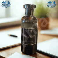 Thumbnail for Noir Spice Eau de Toilette 4.2 fl oz 125 mL black glass bottle with silver winged A logo label on a desk