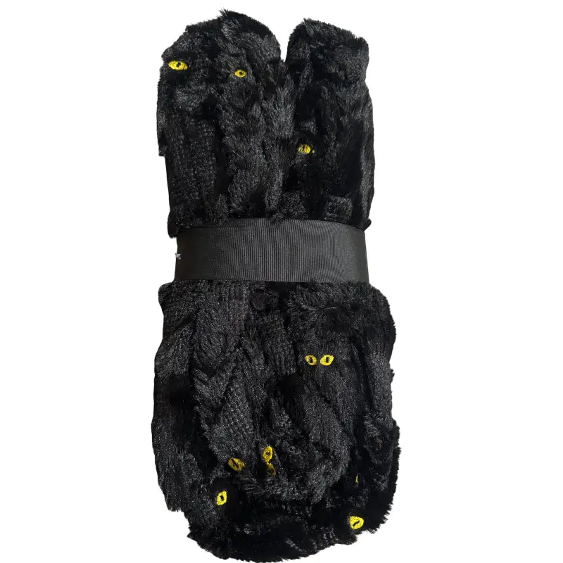 Side profile view of folded black cat embroidered throw blanket