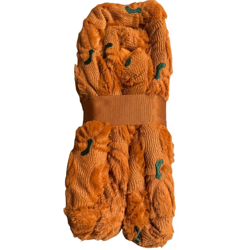 Side folded profile view highlighting textured faux fur pumpkin pattern and green embroidered stems