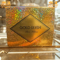 Thumbnail for Top view of Paris Hilton Gold Rush EDP box showing diamond logo label on gold glitter finish
