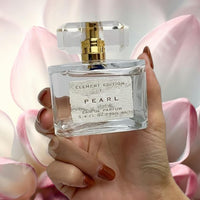 Thumbnail for PEARL perfume 3.4oz with crystal cap and gold sprayer hand view
