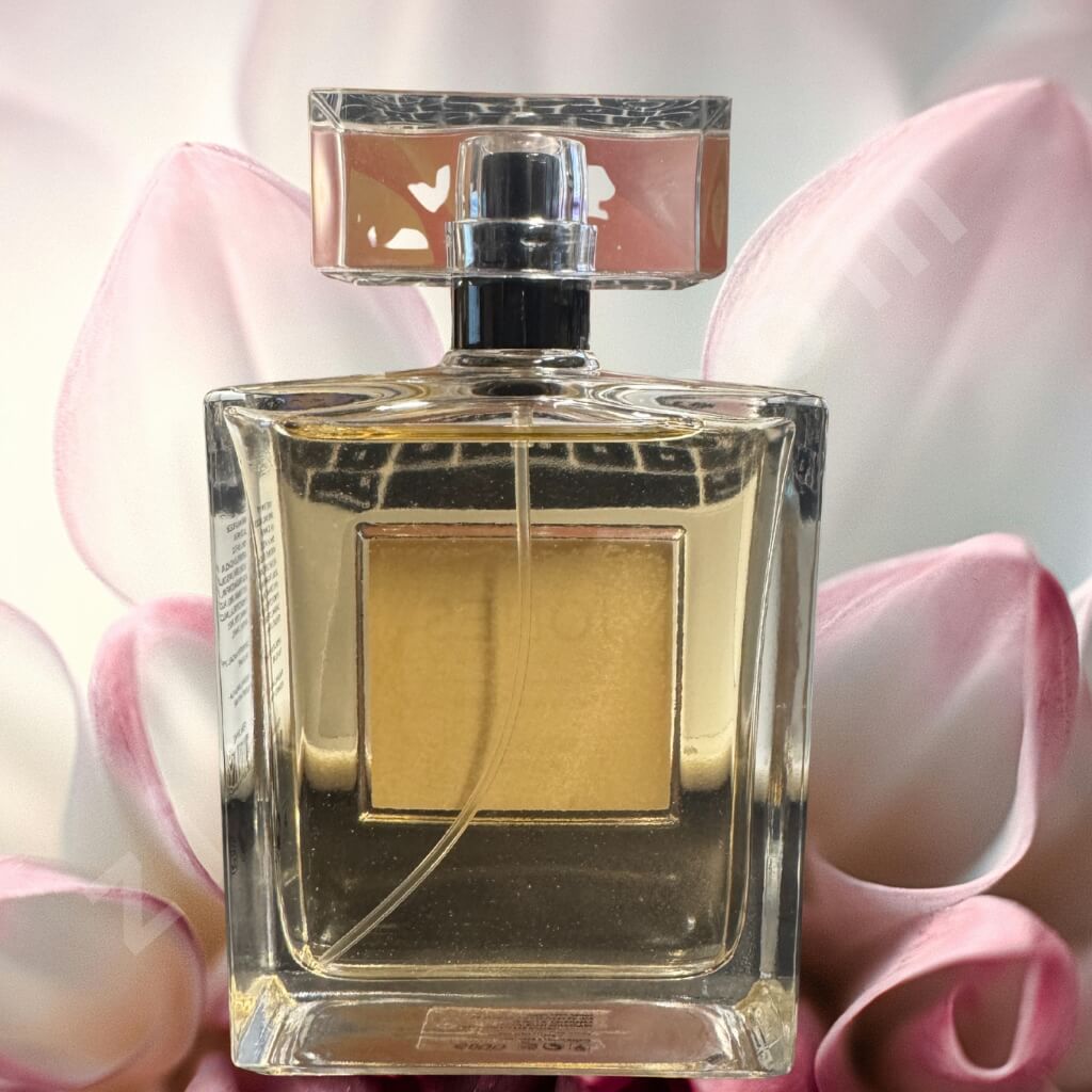 Perfume bottle with a silver cap on a pink floral background “Rare Vanilla Blossom perfume 3.4oz crystal cap clear rectangular bottle