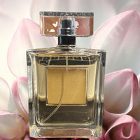 Thumbnail for Perfume bottle with a silver cap on a pink floral background “Rare Vanilla Blossom perfume 3.4oz crystal cap clear rectangular bottle