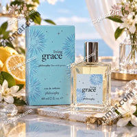 Thumbnail for Philosophy Living Grace eau de toilette box beside clear glass bottle with silver cap and blue starburst label
