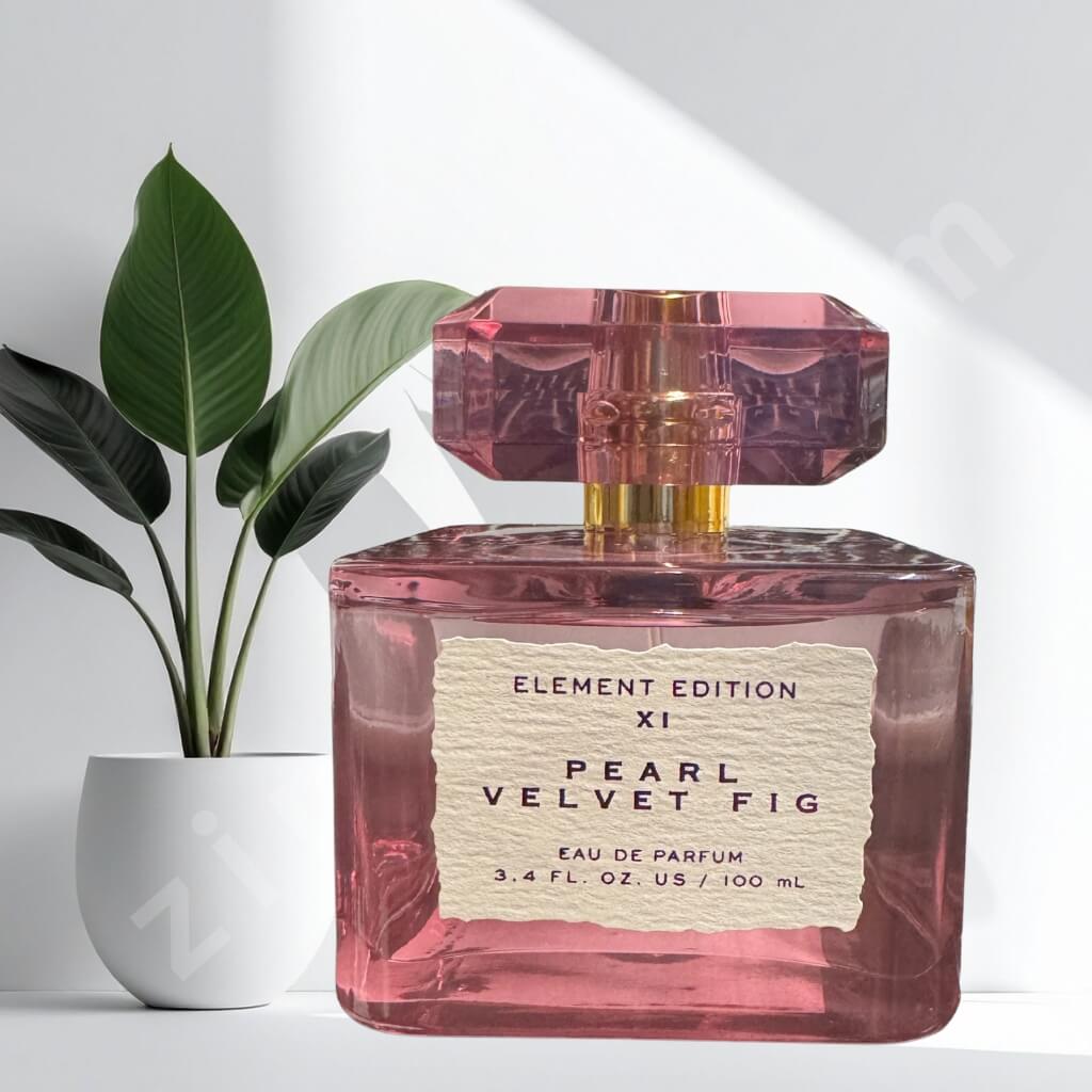 Pink perfume bottle labeled 'Pearl Velvet Fig' with a plant in the background