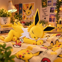 Thumbnail for Pokemon sleeping Jolteon plush resting on a Pikachu patterned blanket”