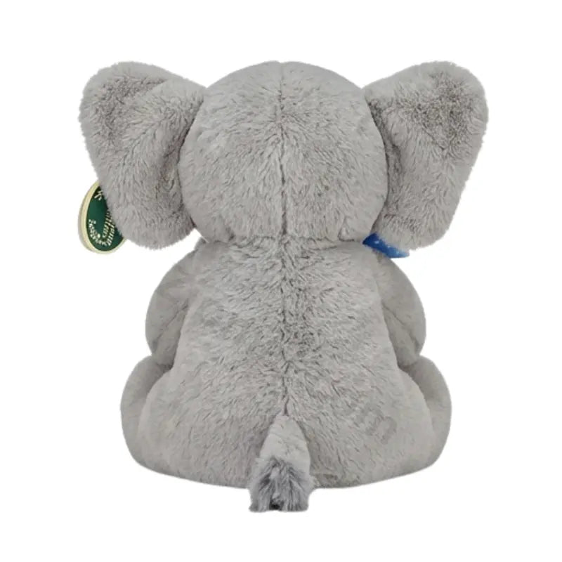 Gray elephant plush toy back view with a green and gold hang tag on the ear and a tufted tail
