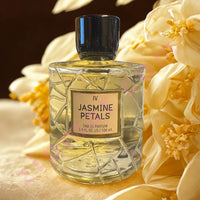 Thumbnail for Perfume bottle labeled 'Jasmine Petals' surrounded by flowers