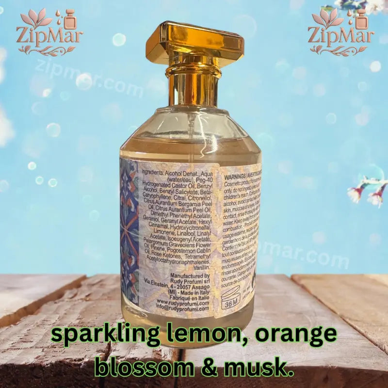 Back bottle view showing ingredients list, manufacturer details, and fragrance scent notes