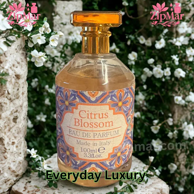 Rudy Profumi Citrus Blossom EDP bottle displayed in front of white floral garden backdrop