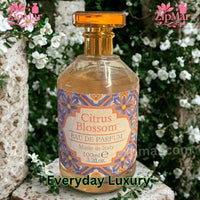 Thumbnail for Rudy Profumi Citrus Blossom EDP bottle displayed in front of white floral garden backdrop