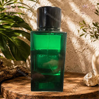 Thumbnail for Sea What Happens Tru Fragrance & Beauty EDC 3.4 oz 100 mL deep green square glass bottle with black cap on rustic wood surface with tropical greenery