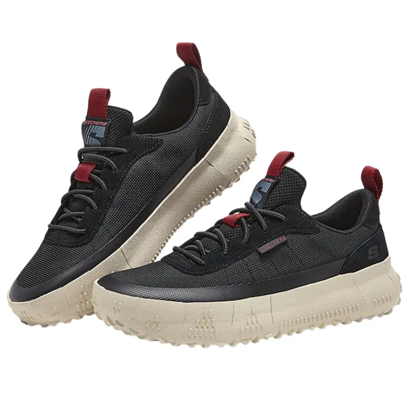Pair of Skechers Classic Fit black sneakers showing thick off-white lugged midsoles