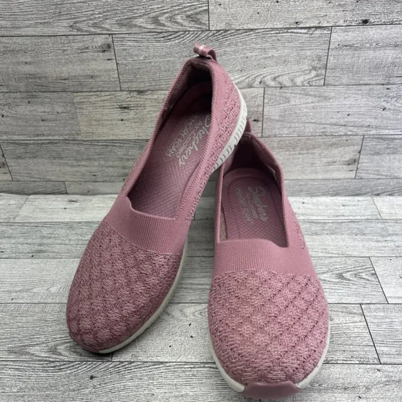 Front and side angled view of Skechers GO WALK Lite Enamored pink slip-ons showing insoles