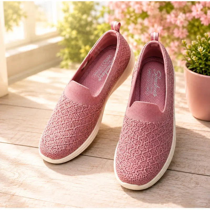 Skechers GO WALK Lite Enamored women's pink slip-on shoes styled on wooden table