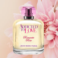 Thumbnail for Perfume bottle labeled 'Addicted to Love Romantic Rose' by Jean Marc Paris with pink flowers in the background.