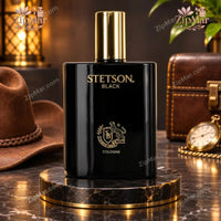 Thumbnail for Stetson Black Cologne 3.4 oz black glass bottle with gold cap and gold crest on marble stand