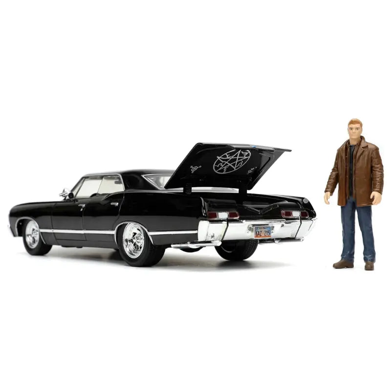 1967 Impala diecast car with trunk open revealing the pentagram symbol and Dean Winchester figure standing nearby.