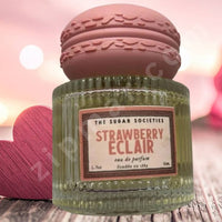 Thumbnail for Green perfume bottle labeled 'Strawberry Eclair' with a pink lid on a wooden surface.