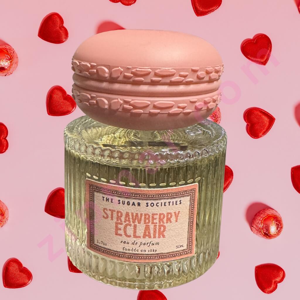 Perfume bottle with macaron lid on a pink background with red heart shapes