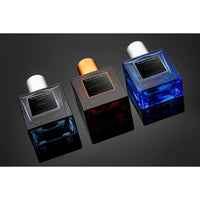 Thumbnail for Top-down angled view of the three distinct fragrance bottles included in the Tahari Men's Gift Set: Aquawave, Leather Oud, and Black (1 oz each).
