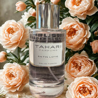 Thumbnail for Tahari Parfums Satin Love perfume bottle surrounded by peach flowers