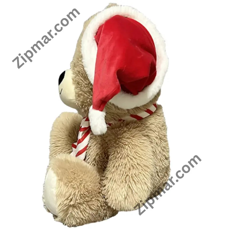 Side view of tan teddy bear plush with red Santa hat, white fur trim and pom pom