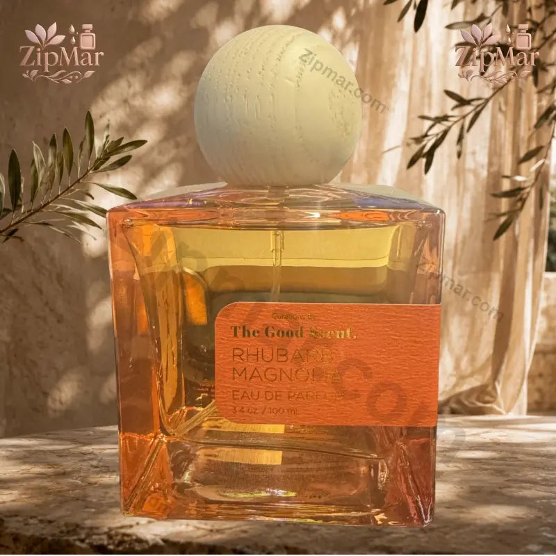 Straight-on view of The Good Scent Rhubarb Magnolia 3.4 fl oz bottle displaying orange texture label