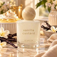 Thumbnail for The Scent Club Vanilla Custard Eau de Parfum 3.4 oz frosted white glass bottle with cream ball cap surrounded by vanilla beans