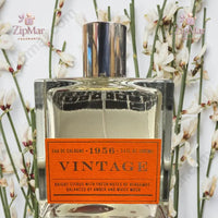 Thumbnail for Tru Fragrance 1956 Vintage Eau de Cologne 3.4 oz bottle overhead view with white orchids