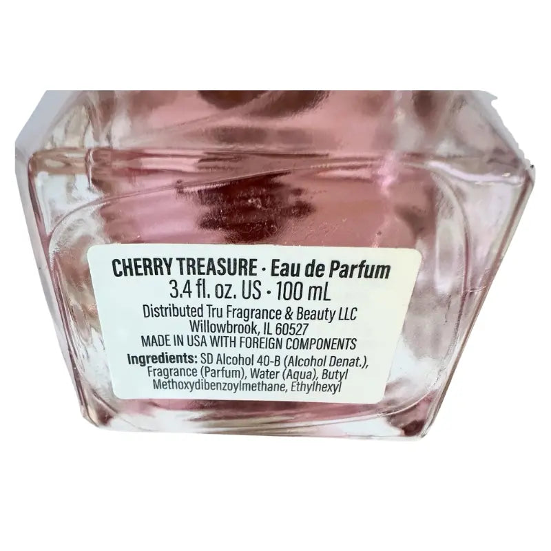 Close-up of the bottom label of Cherry Treasure perfume showing ingredients and 100 ml size.