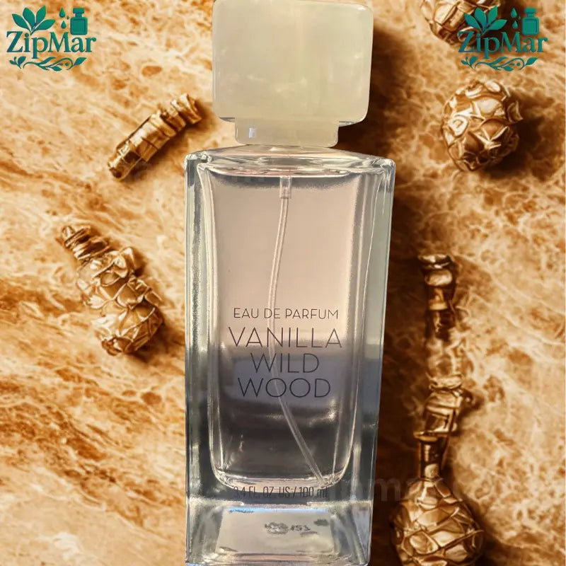 Overhead angle view of Tru Fragrance Vanilla Wild Wood perfume bottle on beige marble backdrop