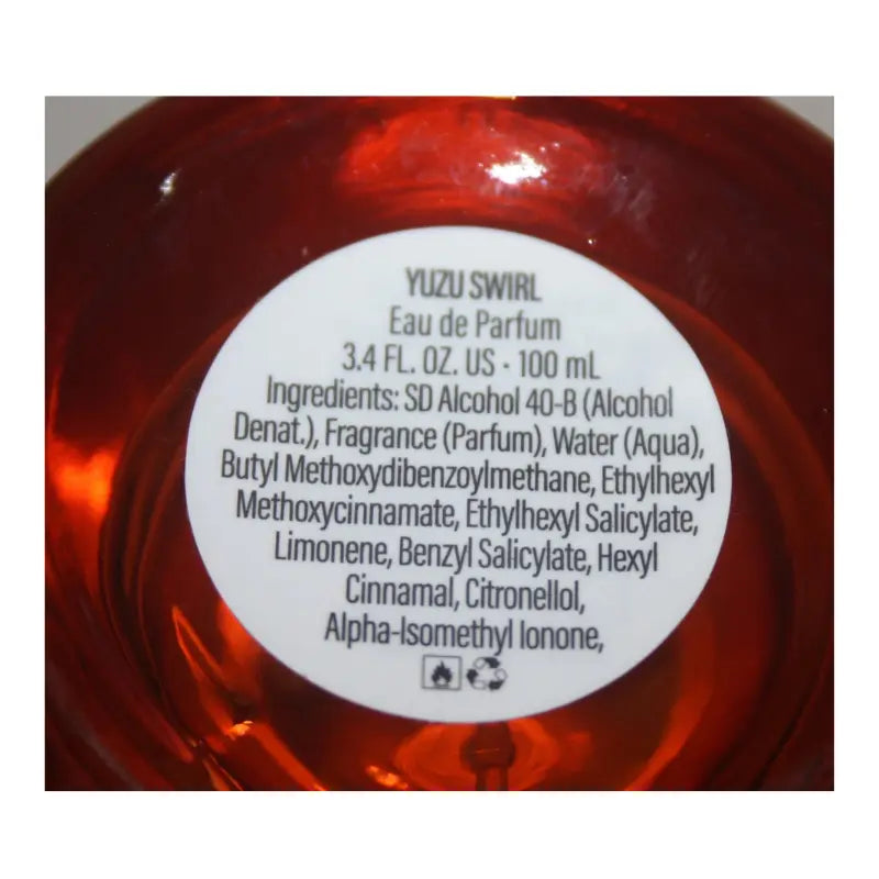 Pair of Tru Fragrance Yuzu Swirl perfume bottles, showing one with the atomizer exposed and the other with its white cap on.