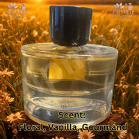 Thumbnail for Back view of Vanilla Wildflower Eau de Parfum clear round glass bottle with golden liquid and dark cap
