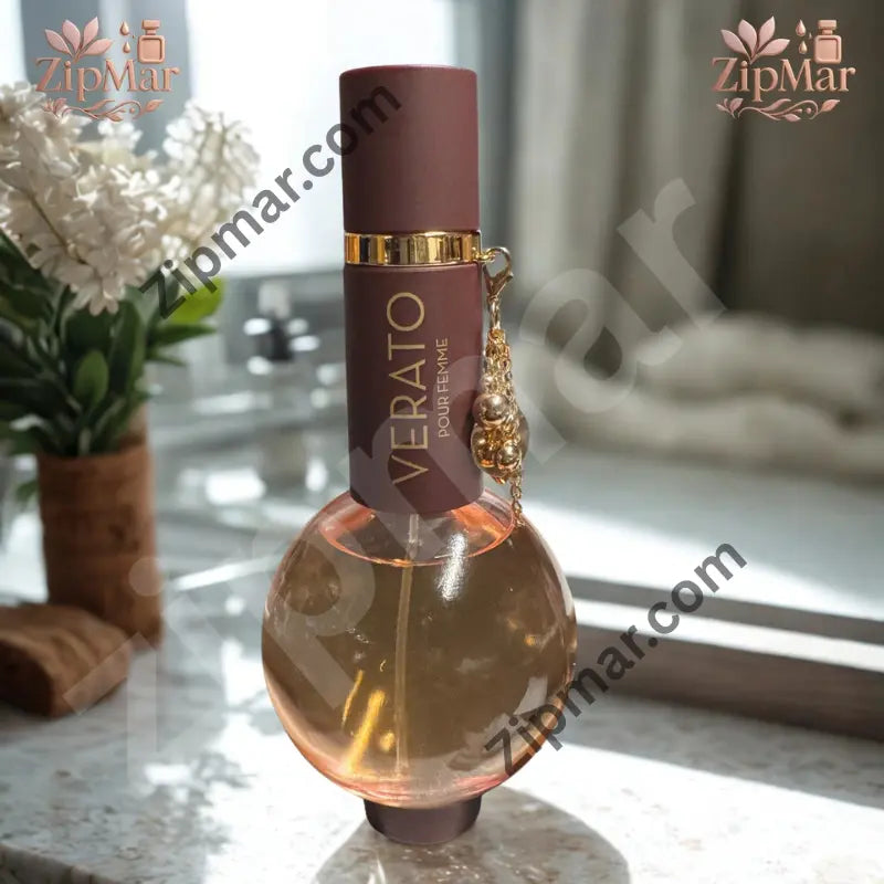 Verato Pour Femme women’s fragrance in a round glass bottle with brown cap and gold charm on a marble bathroom counter