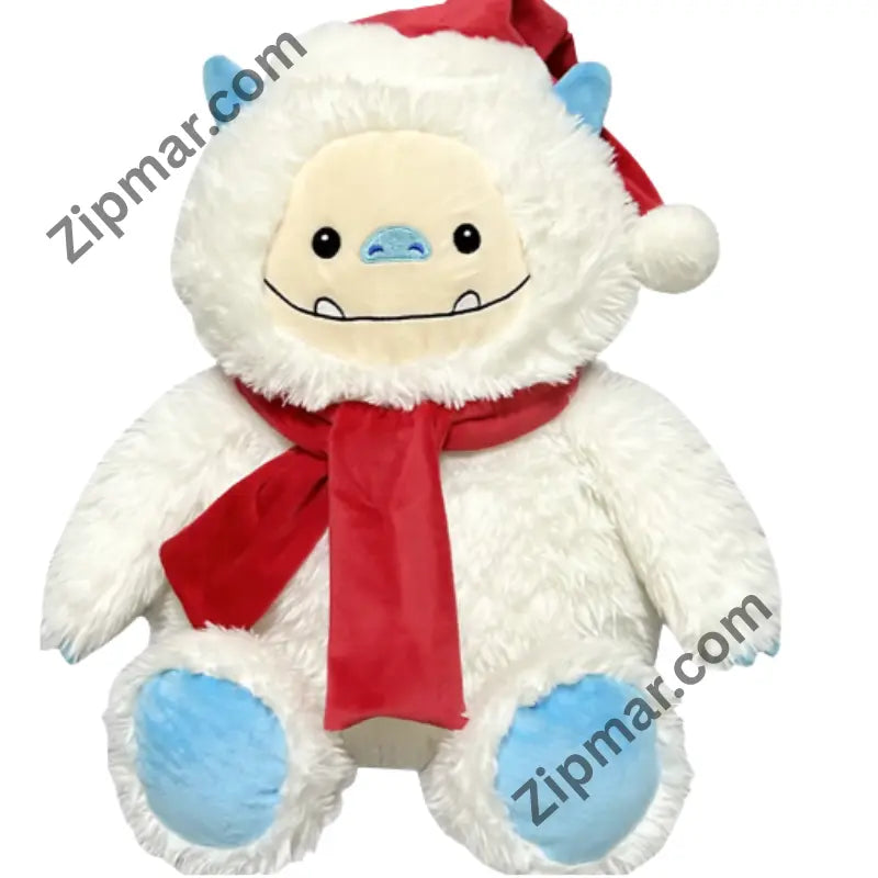 White yeti Christmas plush with red Santa hat, red scarf, blue horns and blue paw pads, front view