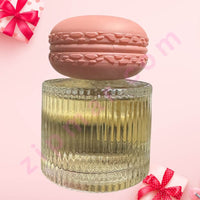 Thumbnail for Decorative container with a pink macaron on top against a pink background with red bows.