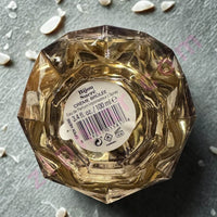 Thumbnail for Decorative glass container with a label on a gray surface