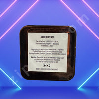 Thumbnail for Amber Intense perfume packaging with label on a blue and pink neon light background