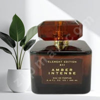 Thumbnail for Amber intense perfume bottle with a plant in the background