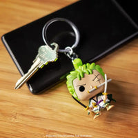 Thumbnail for Roronoa Zoro keychain next to a house key and smartphone on a wooden surface.