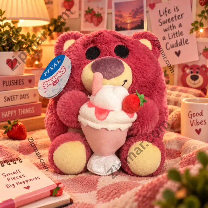 Lotso Snackles plush with strawberry sundae on a pink checkered blanket with cozy props